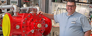 Austin from Hayden and Company in front of a FireDos foam proportioning system