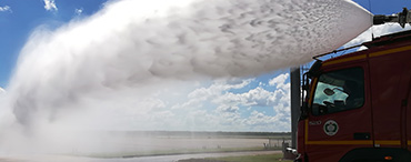 FireDos fire monitor on fire vehicle in action with spray jet